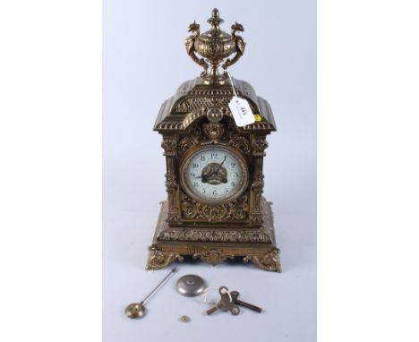 A 19th century brass cased Japy Freres bracket clock with urn finial, white enamel dial with Arabic numerals, eight-day strik