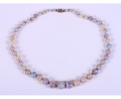 An early 20th century graduated opal bead necklace with a gold platinum topped and milgrain diamond clasp