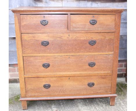 An Arts &amp; Crafts oak chest of two short and three long drawers with brass ring handles, 41" wide