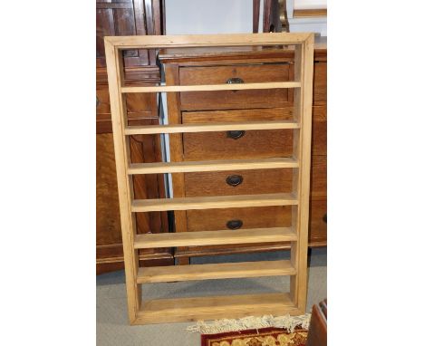 A stripped pine open seven-tier wall shelf, 29" wide