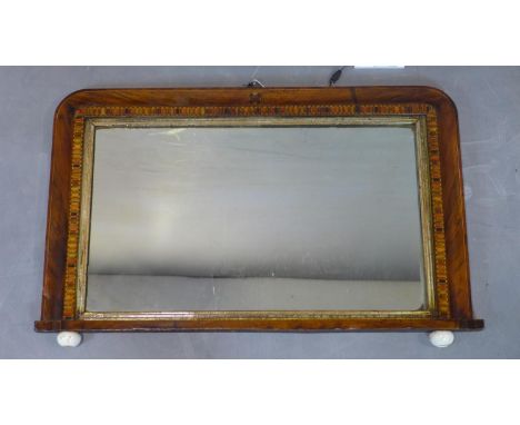 An inlaid walnut overmantle mirror, raised on ceramic ball feet, 44 x 71cm 