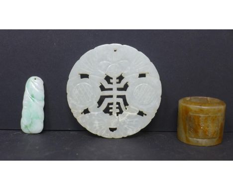 A Chinese celadon jade disk pendant, Diameter 6cm, together with a Chinese agate ring with panels of Chinese inscriptions and