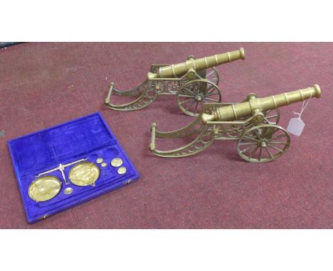 Two bronze cannons H21cm x L41cm&nbsp; and a set of brass scales with weights