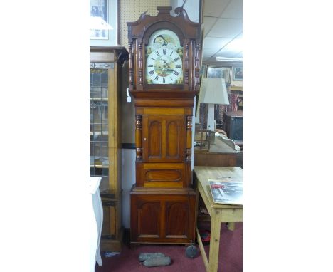 A Victorian mahogany longcase clock, twin train movement, striking bell, with swan neck pediment above two turned pilasters a