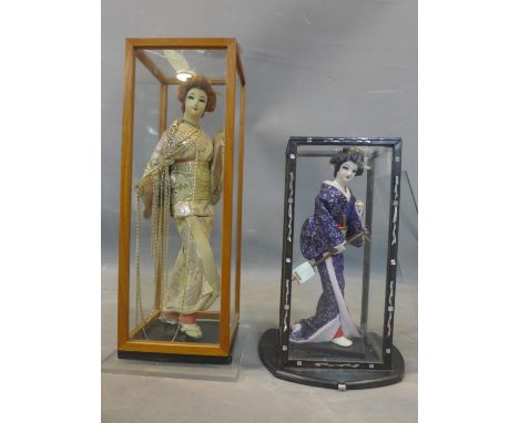 Two Japanese dolls, one holding a samisen, in mother of pearl inlaid display case, H.27.5cm (doll), the other in a part silk 