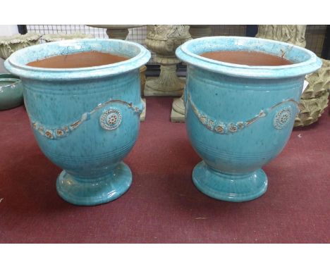 Two large Anduze urn style blue glazed planters, decorated with floral swags, on spreading feet, H.71cm Diameter 61cm 