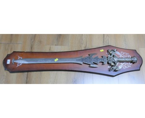 Ornamental sword decorated with dragons on wooden plaque This bladed product is not for sale to people under the age of 18.  