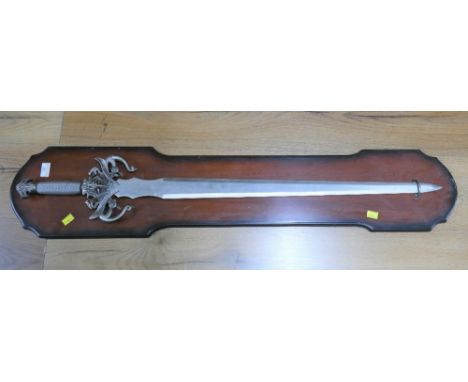 Ornamental sword marked Blest on a wooden display board This bladed product is not for sale to people under the age of 18.  B