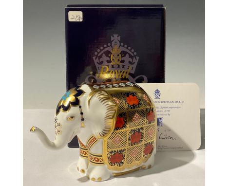 A Royal Crown Derby paperweight, Imari Baby Elephant, with trunk raised, decorated in the 1128 pattern, specially commissione