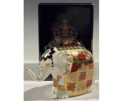 A Royal Crown Derby paperweight, Imari Baby Elephant, with trunk raised, decorated in the 1128 pattern, gold stopper, 10cm hi