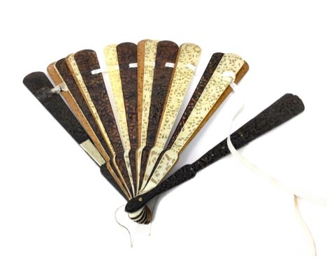 EARLY 20TH CENTURY CHINESE FAN, the sticks in wood and ivory, carved with figures and architectural scenery, the guards 19cm 
