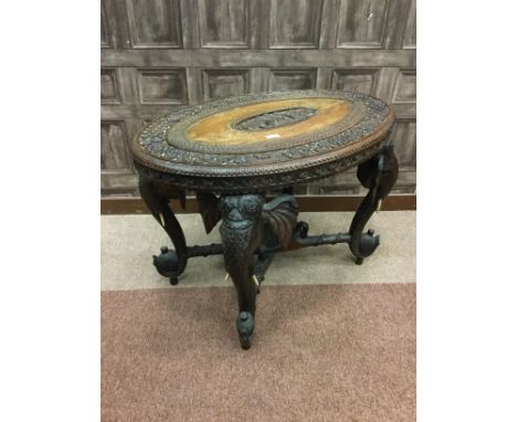 EARLY 20TH CENTURY INDIAN OVAL CENTRE TABLE, carved with central reserve depicting a seated figure and elephants, the border 