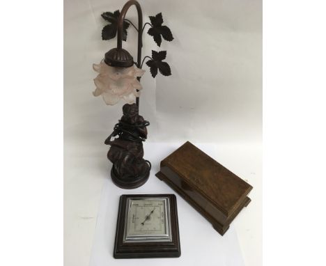 A modern lamp, barometer and wooden box