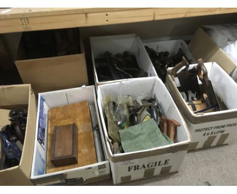 A large collection of woodworking tools including various steel wood planes.