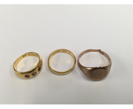 A 22ct gold wedding band 4 grams with 22 ct gold ring inset with diamond and ruby 7 grams and a 9 ct gold ring 5 grams