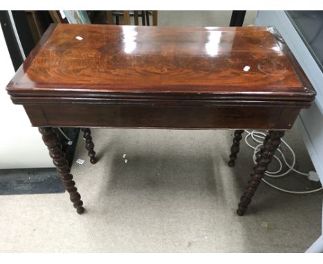 A mahogany and crossbanded card table on barley twist legs. Size approx 85x42x74.5cm