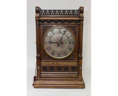 A fine quality Victorian Gothic revival bracket clock, triple Fusee. Chimes on bells and gong. the oak case carved with typic