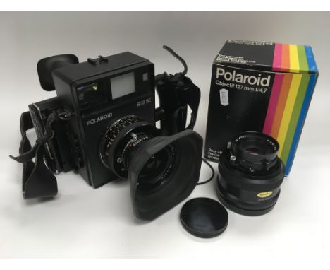 A Polaroid 600 SE camera plus two Mamiya lenses.