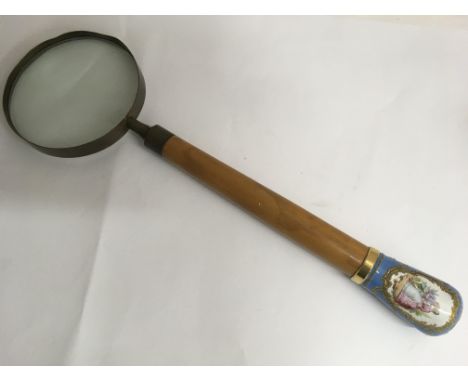 A large magnifying glass with French style, painted enamel handle. Approx 35cm long