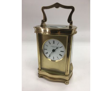 A brass cased carriage clock by J Horton & Son, London.