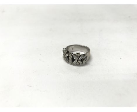 An 18ct white gold ring set with a pattern of baguette diamonds. Weight approx 7g, size approx K/L.