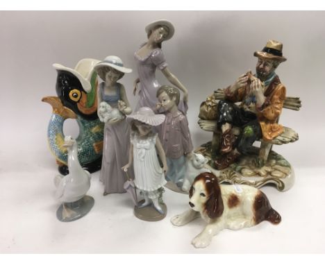 A collection of ceramics including Nao figures, a Winton glug jug etc.