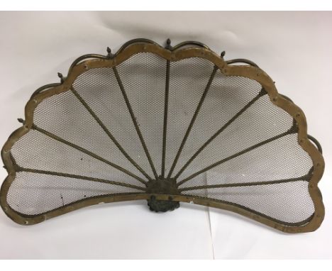 A fan shaped brass fire screen. Approx 59cm wide