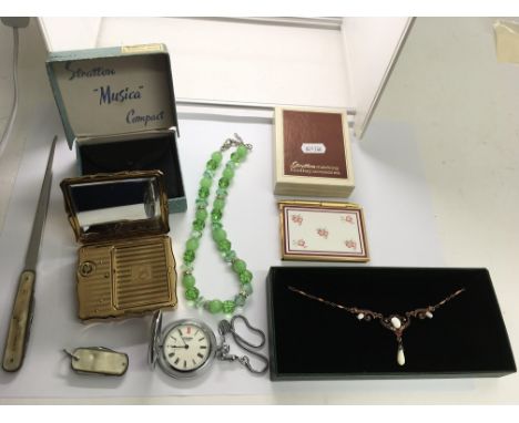 A boxed Stratton musical compact and notebook, a green glass bead necklace and odds