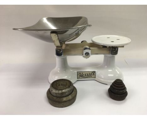 A set of Harrods enamel kitchen scales with weights.