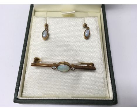 A 9ct gold opal brooch and earrings. Weight approx 3.08g