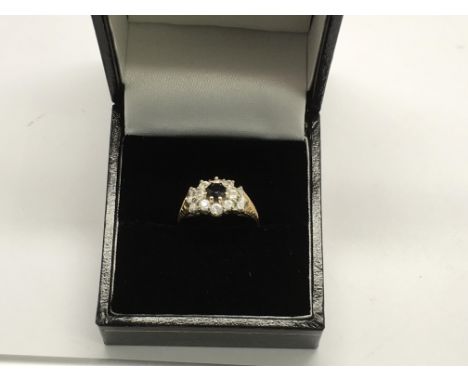 A 9ct sapphire cluster ring. Approx size K