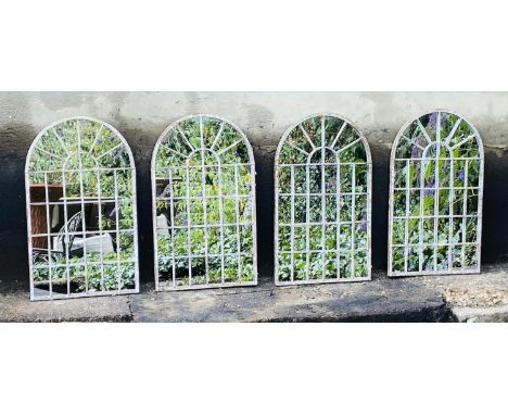 ARCHITECTURAL GARDEN WALL MIRRORS, a set of four, aged metal arched frames, 60cm x 36cm. (4) 
