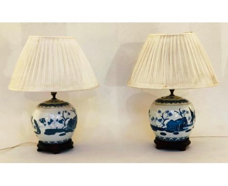 TABLE LAMPS, 58cm H, a pair, Chinese blue and white ceramic of jar form with carved wooden bases and shades. (2) 