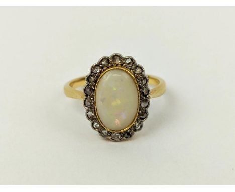 AN 18CT GOLD OPAL AND DIAMOND SET DRESS RING, platinum set, probably Edwardian, the oval set cabouchon opal with a diamond su