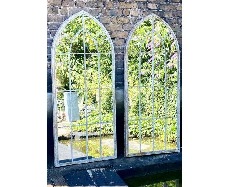 ARCHITECTURAL GARDEN WALL MIRRORS, a pair, aged metal frames 160cm x 67cm. 