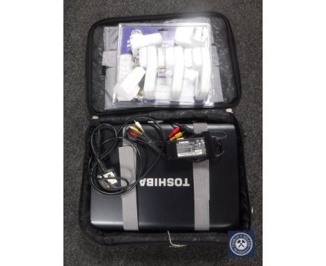 A Toshiba lap top with charger in case, two LED push lights and timer switches 