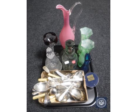 A tray of box of assorted table cutlery, glass ware, etched decanter depicting a leaping stag, coloured glass vases, paperwei