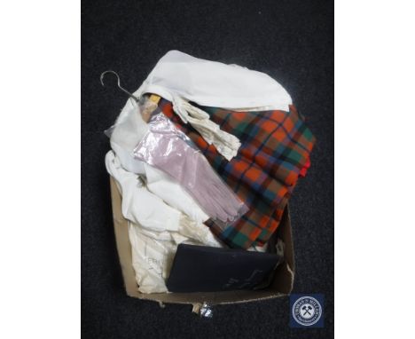 A box of vintage clothing including gloves, Scottish kilt, blouse, book of fabric samples 