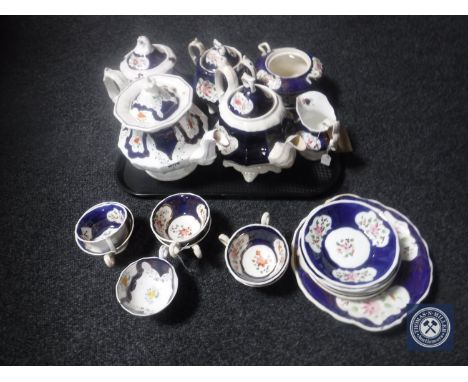 A tray containing twenty-one pieces of Victorian lustre tea china