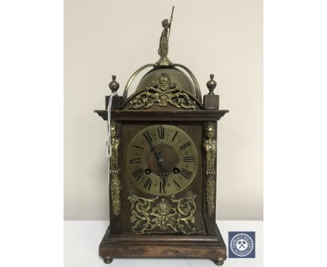 A late 19th century oak and brass lantern clock