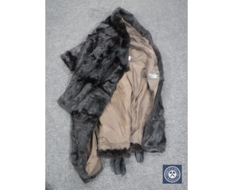 A lady's fur coat, dark brown, with belt. 