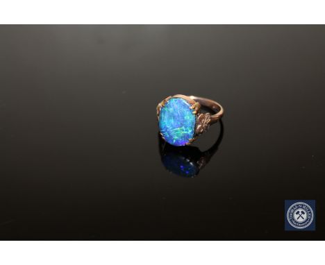 A 9ct gold doublet opal ring, size O CONDITION REPORT: 3.5g. The opal is a doublet and has typical fine surface abrasions, as