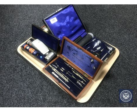 A tray of boxed instruments including Coronia razor, drawing utensils, cased vintage 'Ultra Lens' etc