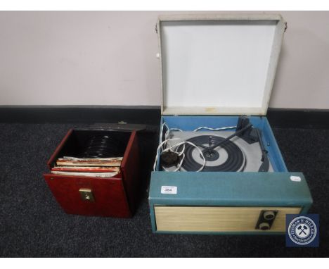 A mid 20th century electric table top record player and a case of 45's - 60's and later 