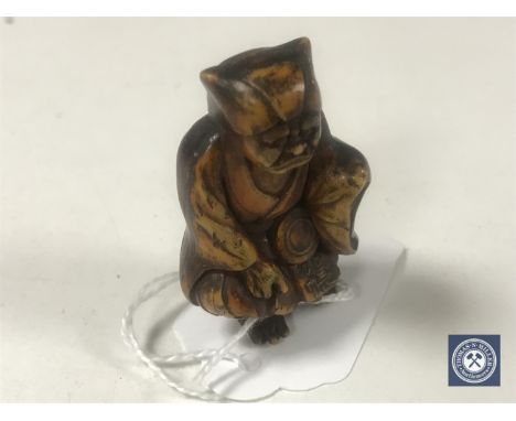 A hardwood netsuke - Village Elder. 