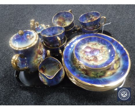 A tray containing a twenty-one piece hand-painted Marquis tea and dinner service