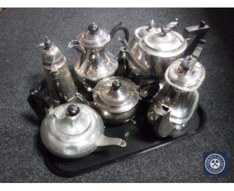 A tray of seven assorted antique silver plate and pewter tea and coffee pots