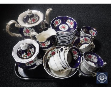 A tray of thirty-three pieces of Victorian lustre tea china 