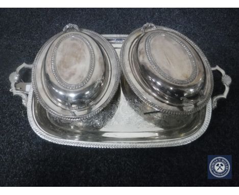 A plated twin handled serving tray, pair of plated entree dishes with covers 