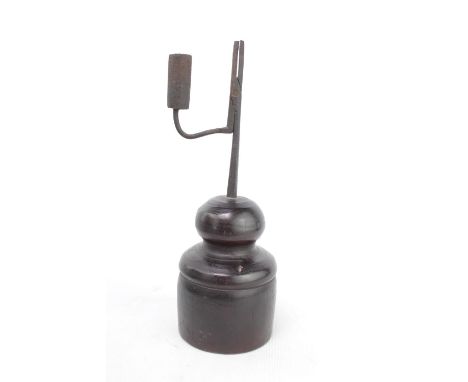 An 18th century wrought iron rush light, with turned wooden base 25cm in height 